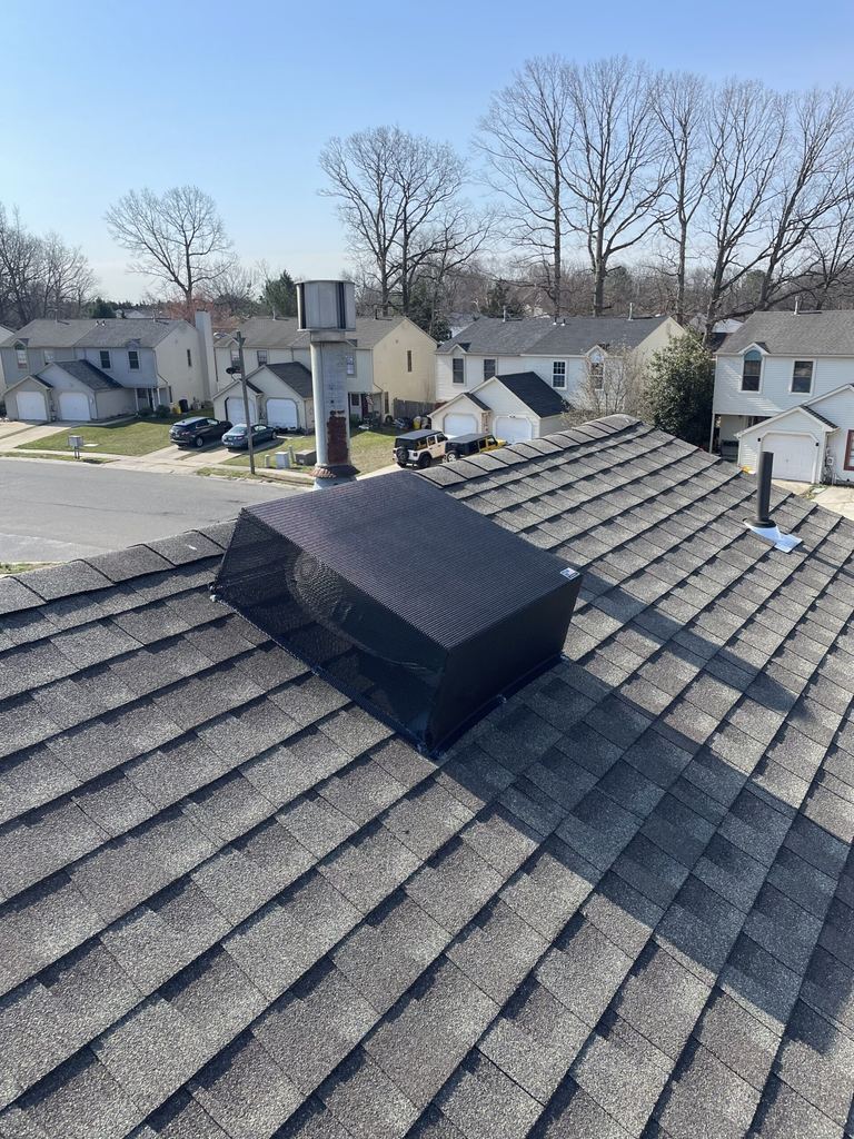 Black exhaust vent cover fitted on an asphalt shingle roof in Sewell, NJ