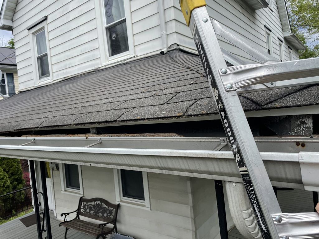 Ladder against the roofline and gutter of a Moorestown, NJ home